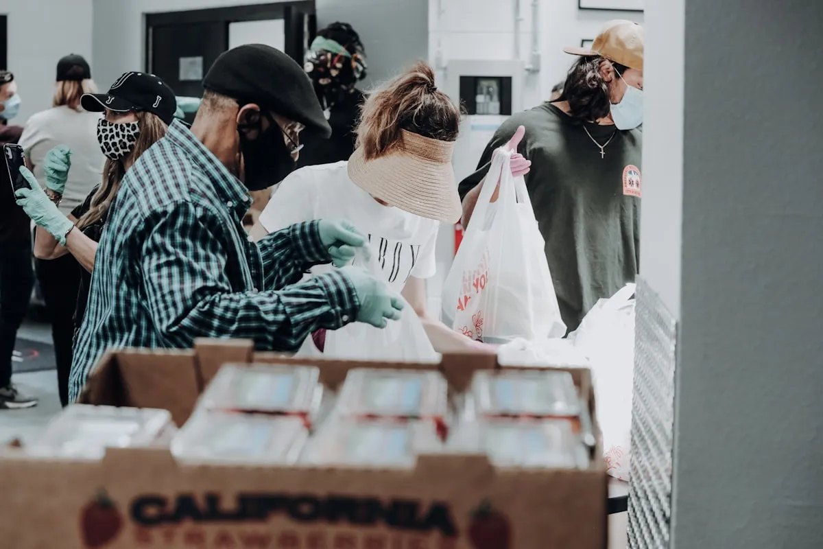 Volunteers organising boxes of donated supplies at a food bank