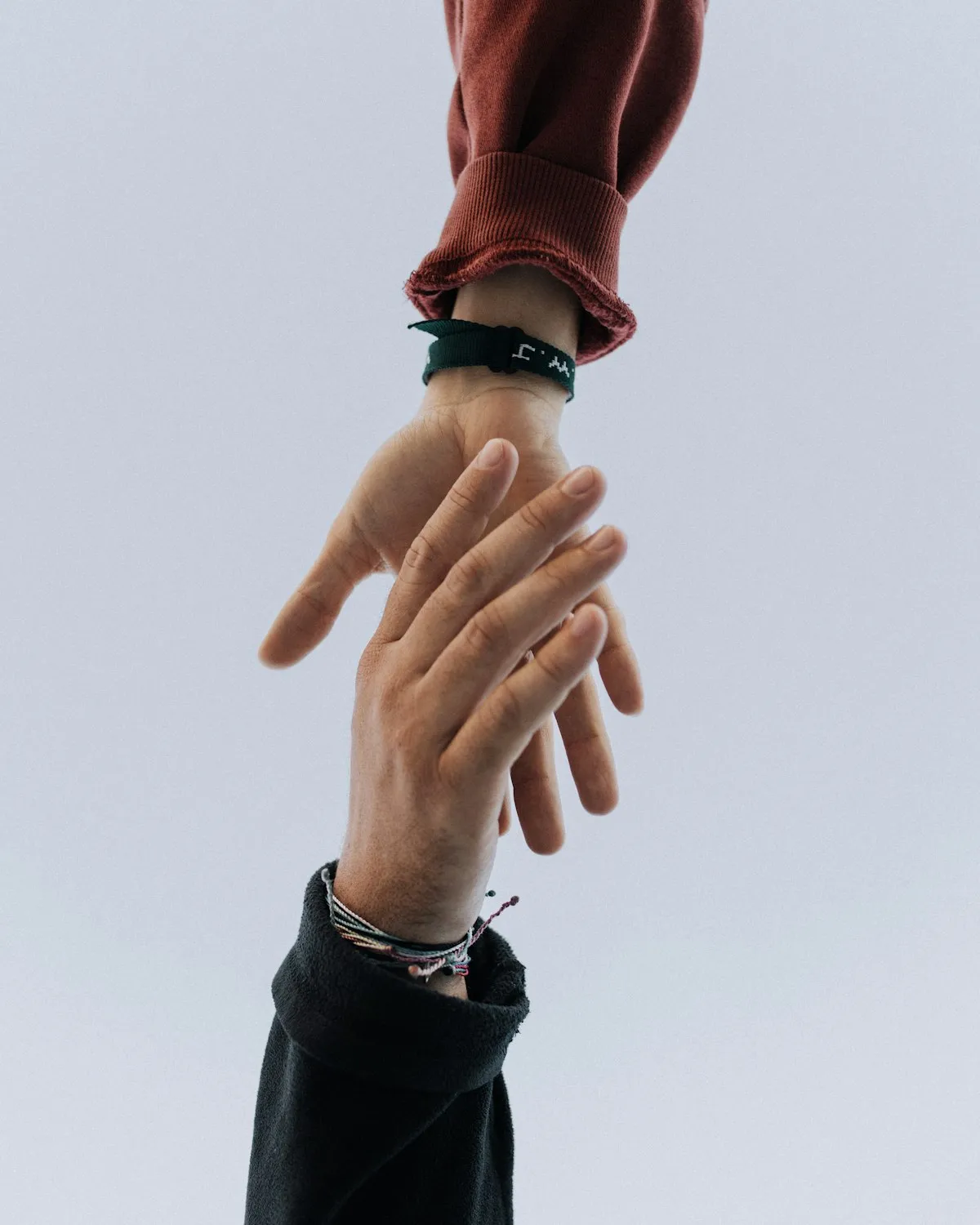 One person offering a helping hand to another